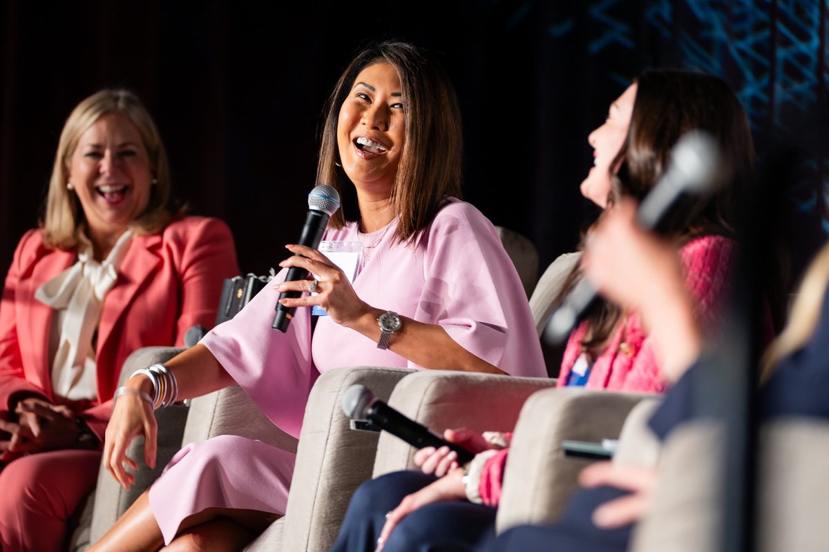 Women in Business Summit — panel of women leaders on stage